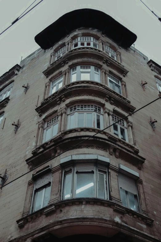 an architectural building with many windows and a telephone line in front of it