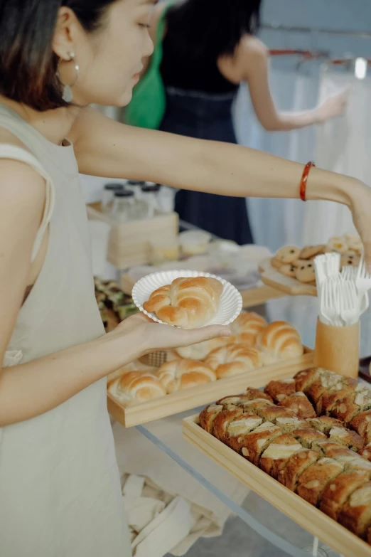 a woman is placing food on a tray