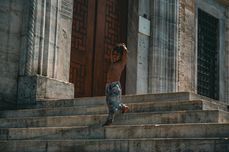 a person standing on some steps with his foot on the wall