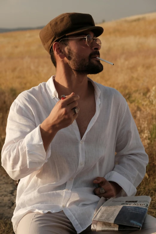 the man is sitting on a wooden bench with a cigarette