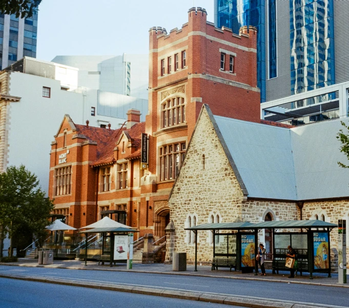 people are standing outside in a courtyard of some buildings