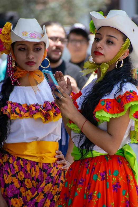 two young ladies are dressed up for a festival