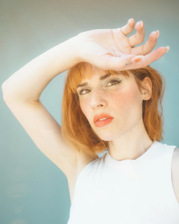 a girl posing with her hands above her head