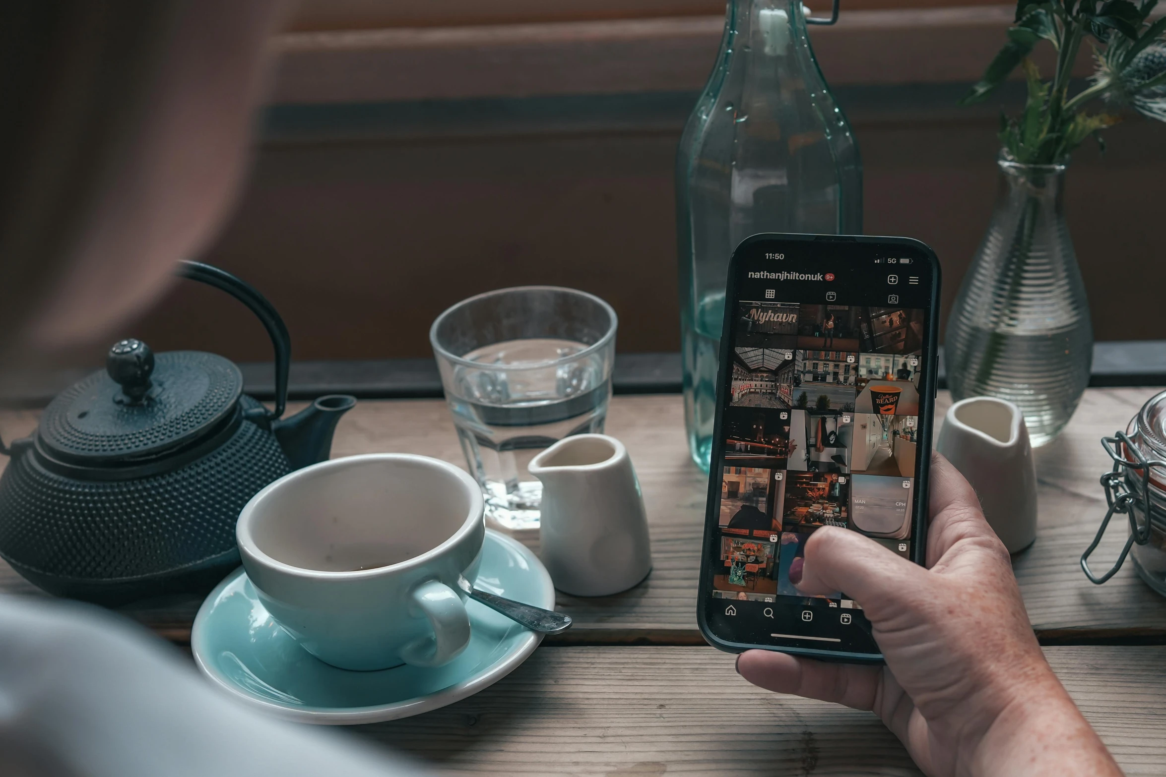 a person is taking a po of them cup of coffee and milk