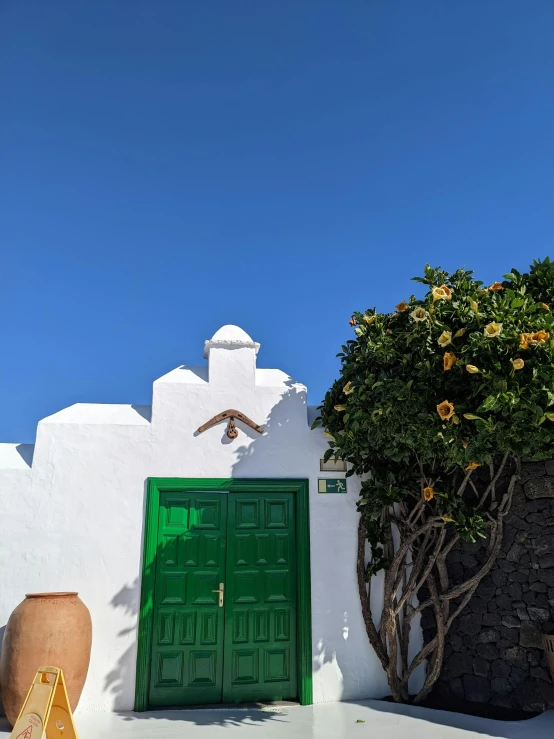 a green door on the side of a building