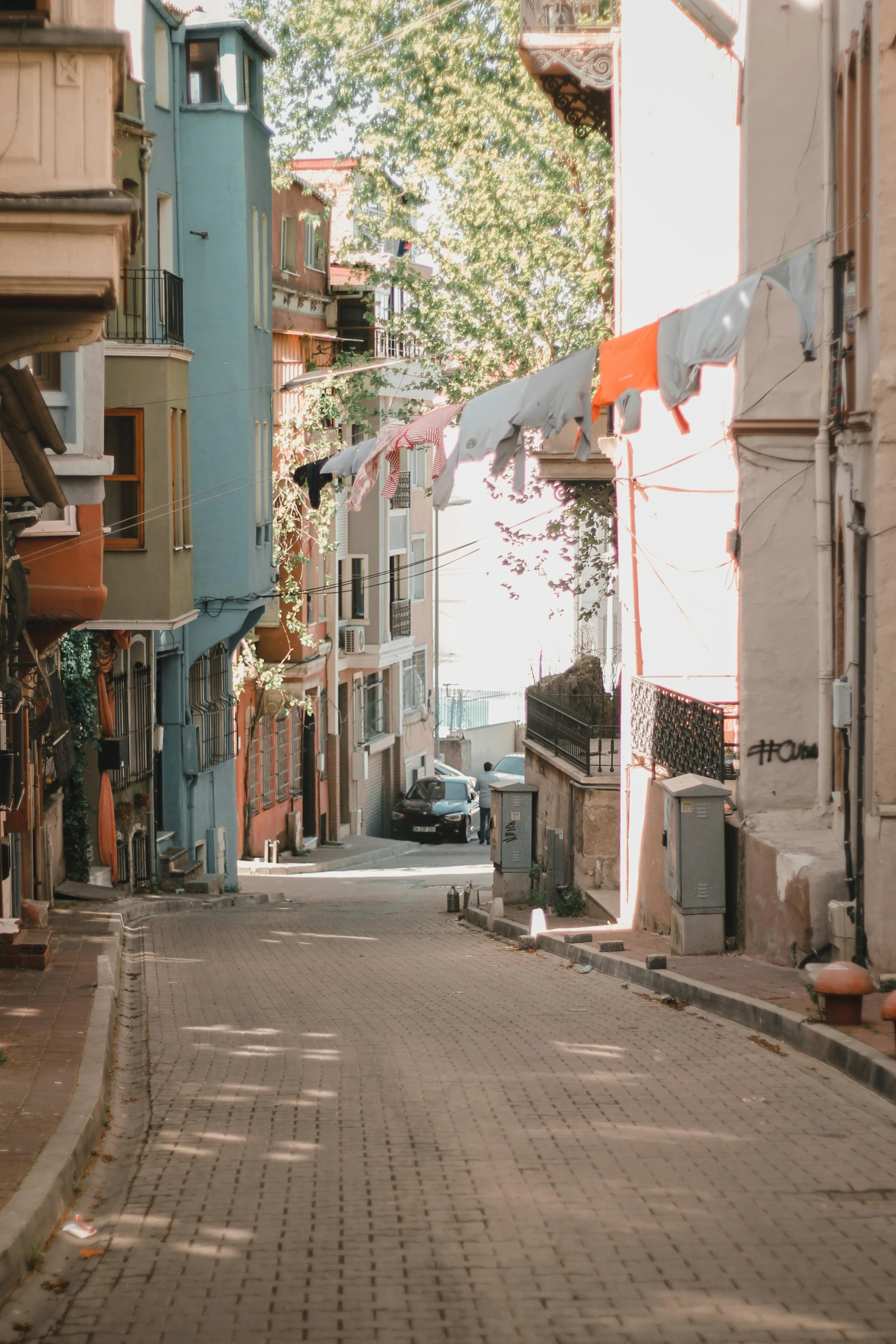 the street lined with buildings is made from concrete