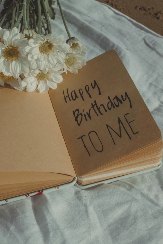 an open book that has the words happy birthday to me written on it