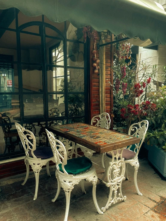 an outdoor table set with chairs for eight