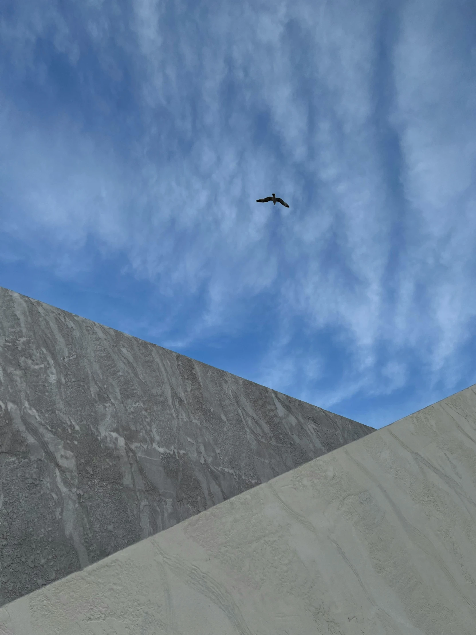 an airplane flying over the top of a tall mountain