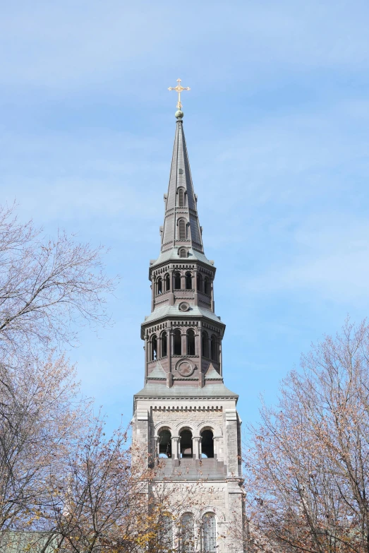 a very tall church steeple with an ornate clock on it