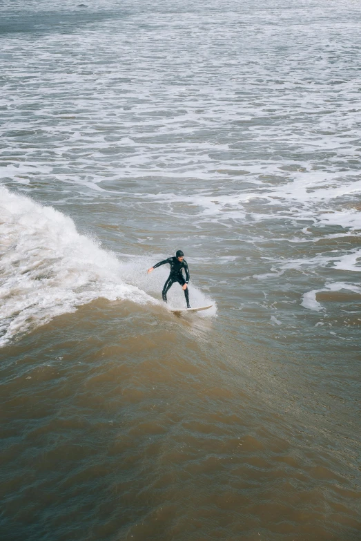 surfer catching a wave on the beach