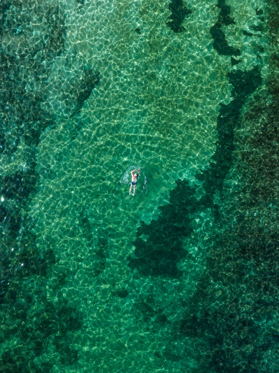 two people are in a small boat on the water