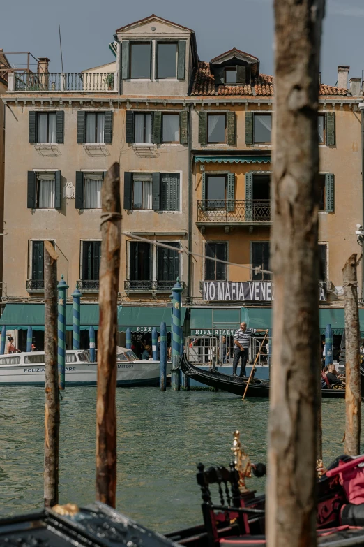 a large building near a boat dock with lots of boats around