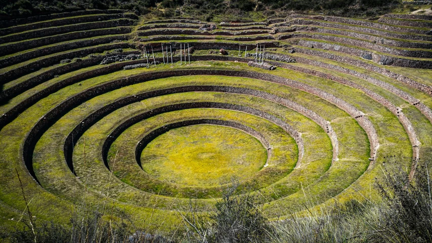an aerial view of a round structure made out of grass