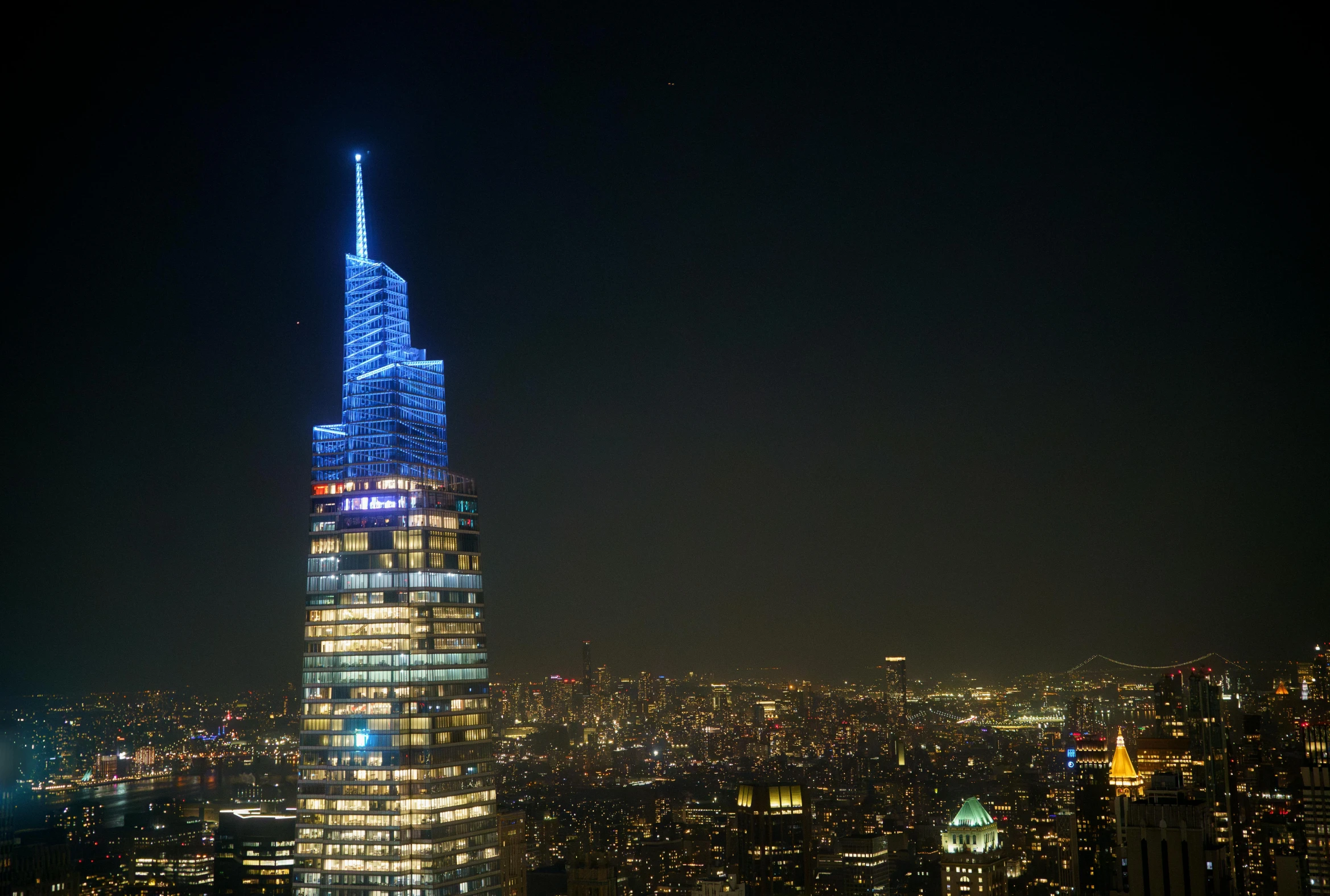 a lit up building with the words'empire tower in a city at night