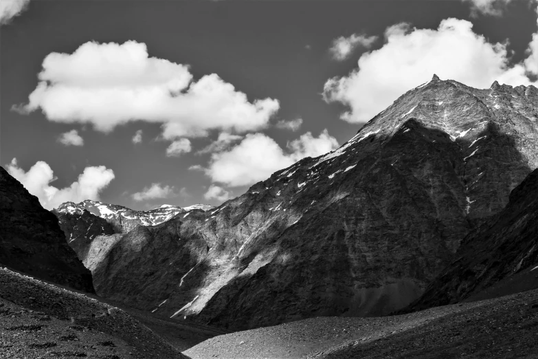 a mountain is covered in snow and clouds