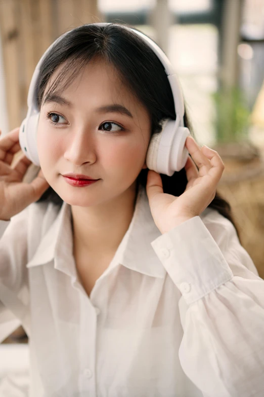 a woman wearing headphones and smiling at the camera