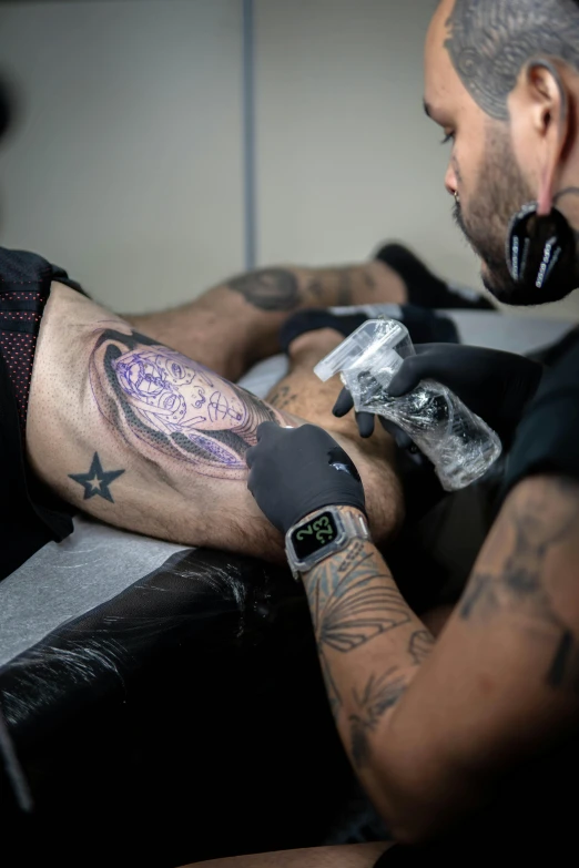 the tattooed man is wearing an ipod wrist watch