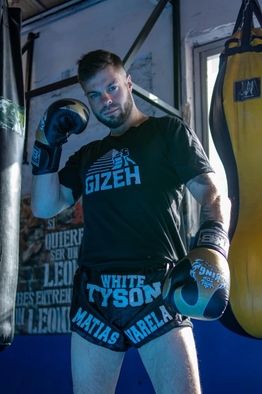 a young man is holding onto his gloves