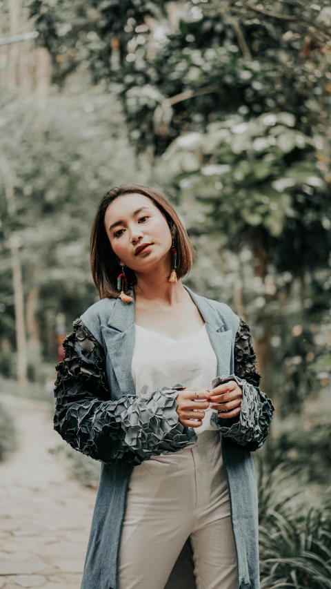 the young woman is wearing a blue jacket and white shirt