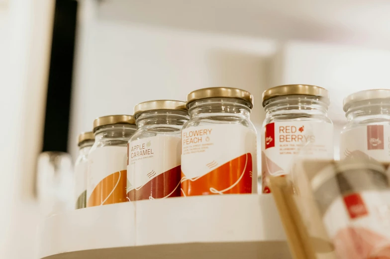 bottles sitting on a shelf with labels on them