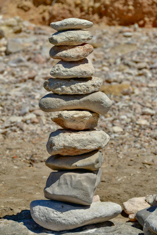 rocks sitting on the ground stacked together in a pyramid