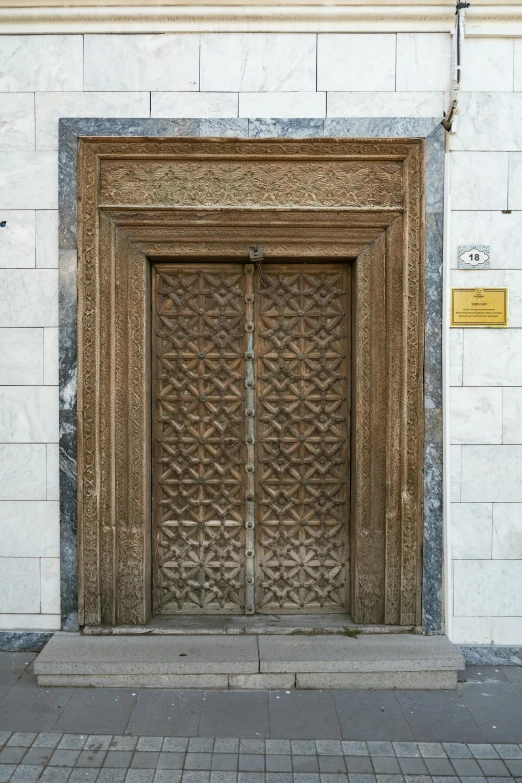 a wooden door stands by an elegant window