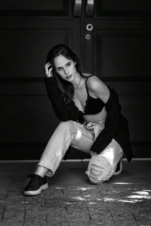 a women kneeling on the ground next to a garage door