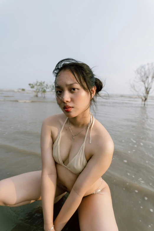 a  woman sitting in the ocean on top of a boat