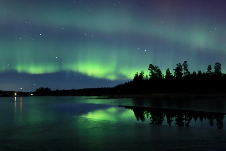 a beautiful reflection of the aurora bore in the lake