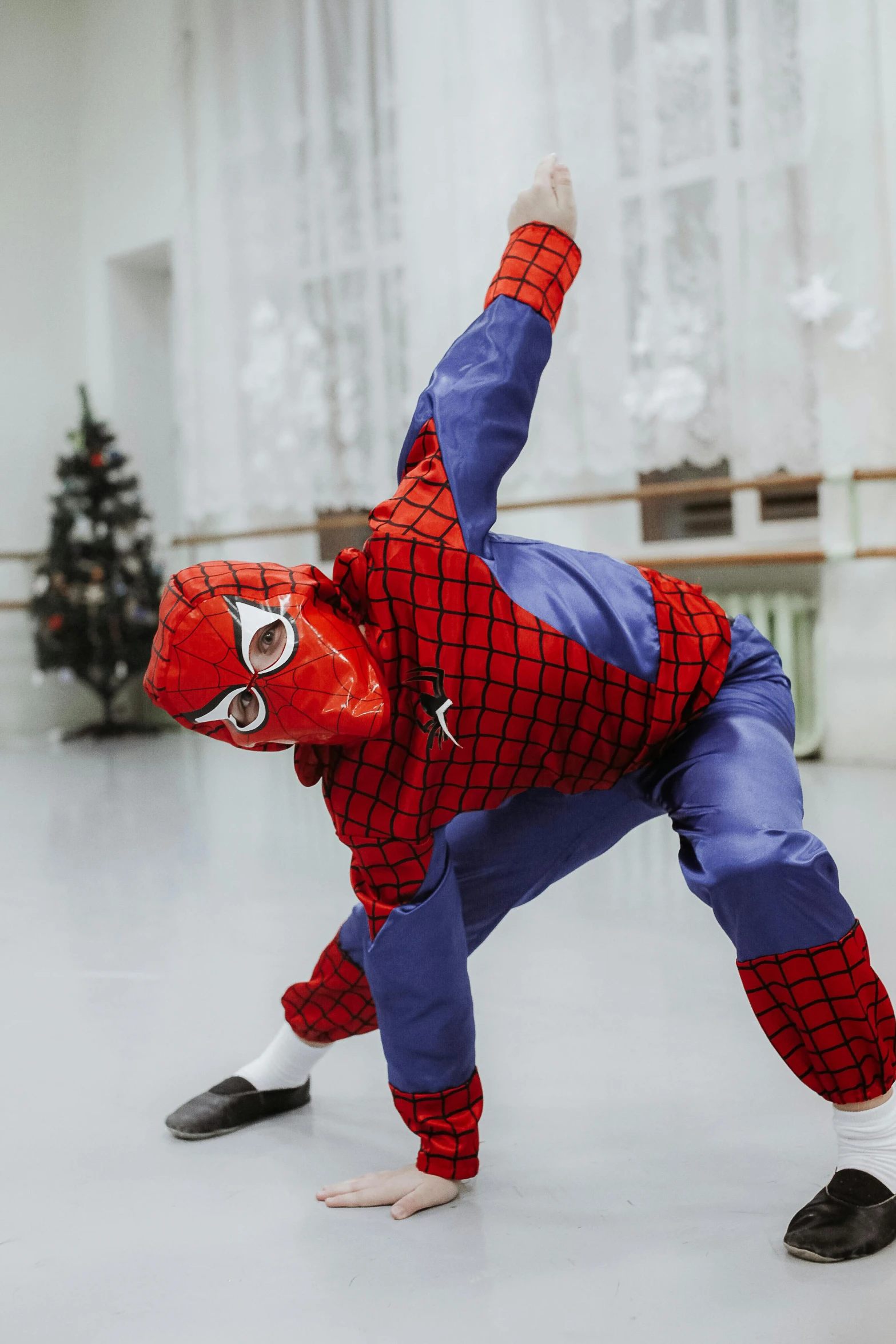 spiderman doing a sidehand maneuver in the dance studio