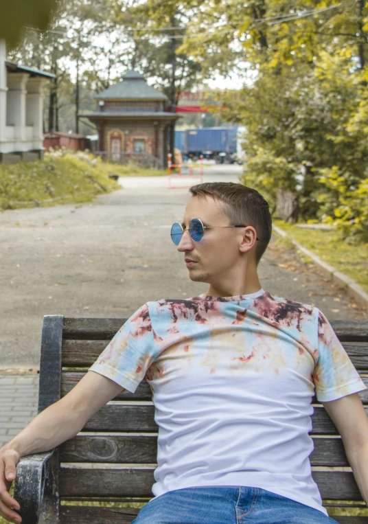 a man is sitting on a bench outside