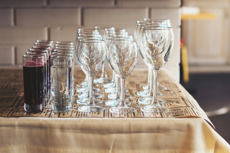 several empty wine glasses lined up on a table