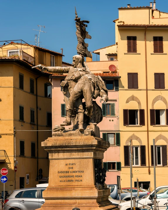 a statue stands in front of a row of buildings