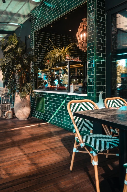 the patio is decorated with green tiles and wicker