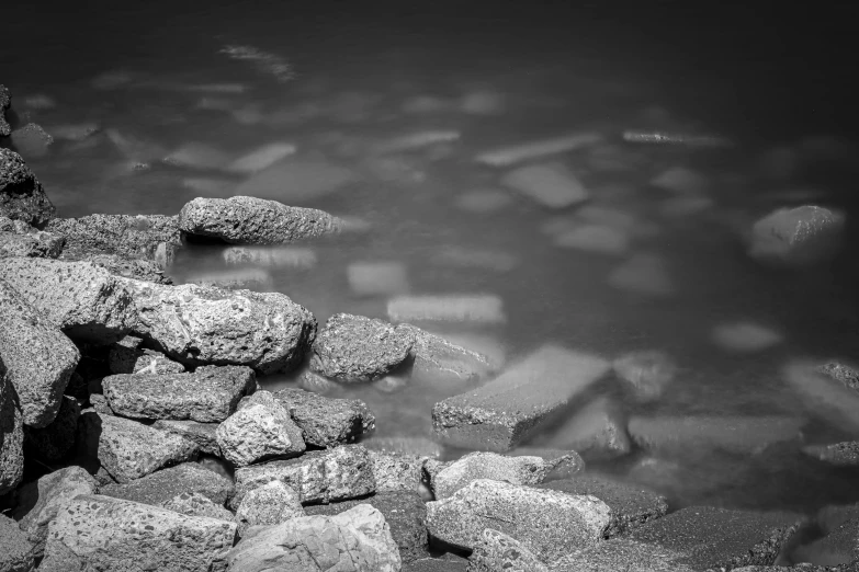 the rocks and water in a lake with rocks