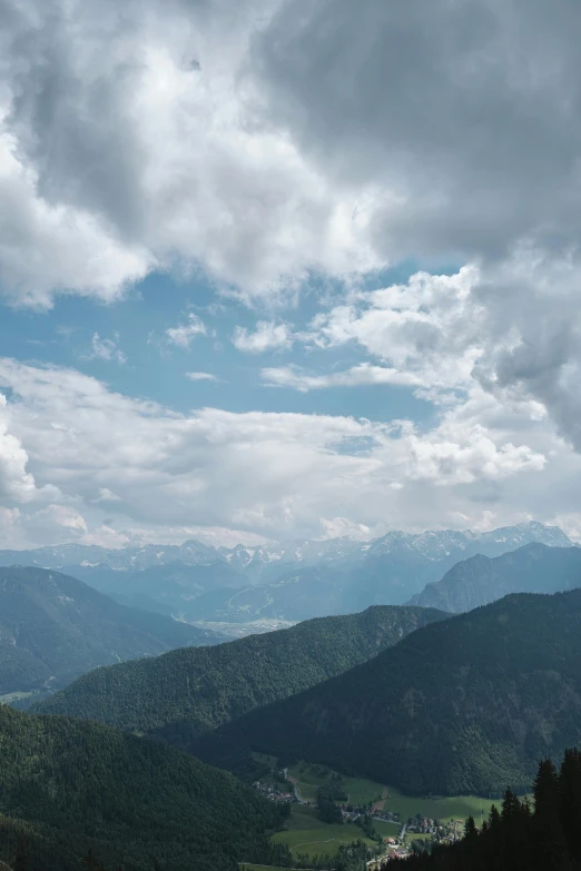 a scenic view of a forested mountain range