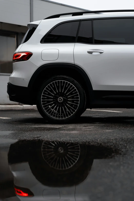 a white mercedes benz parked on the side of a building