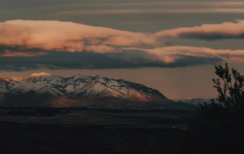 the mountain range is glowing in the distance