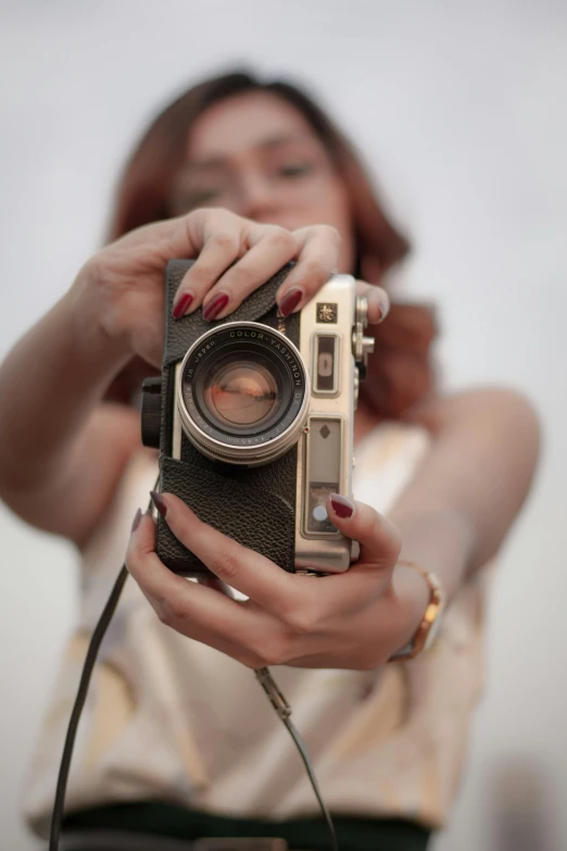 a woman takes a selfie with a camera