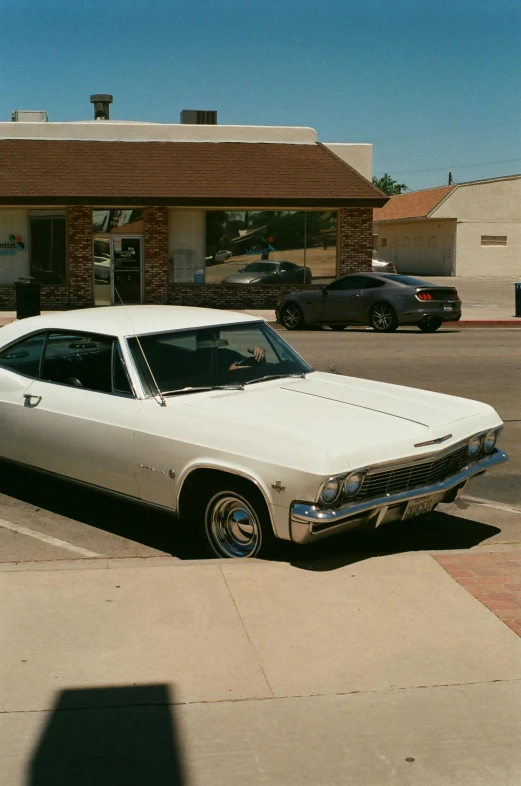 a car parked in a parking lot next to a building