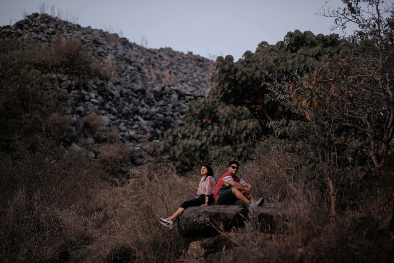 two people are sitting on top of an animal