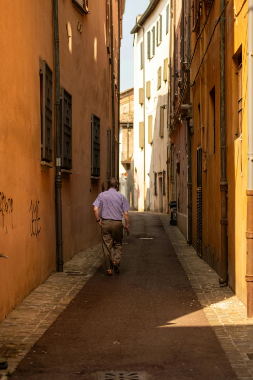 a man walks down an alley way in an alley