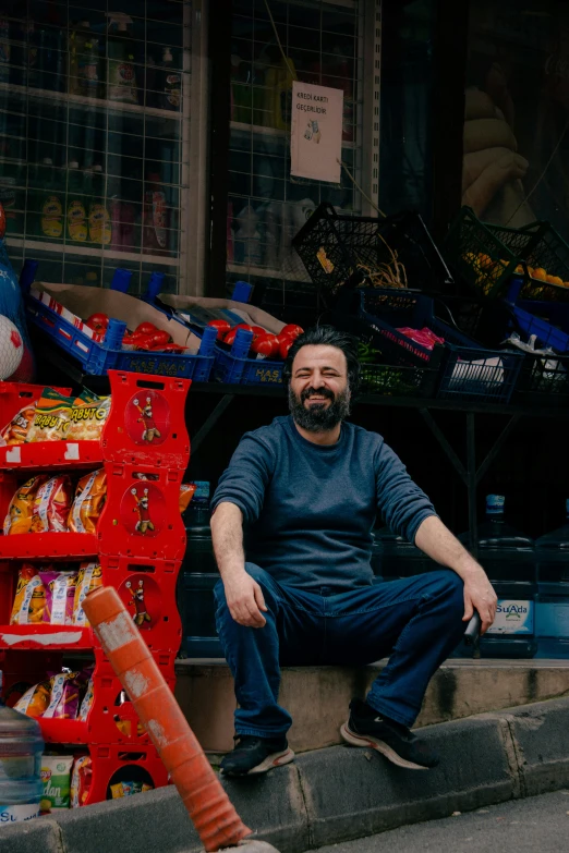 a man is sitting on the steps near some food