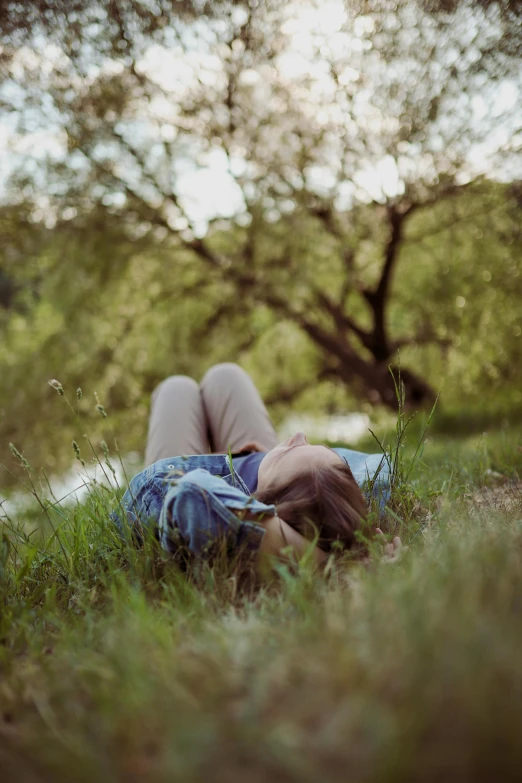 a person laying on the ground with their head in a pillow