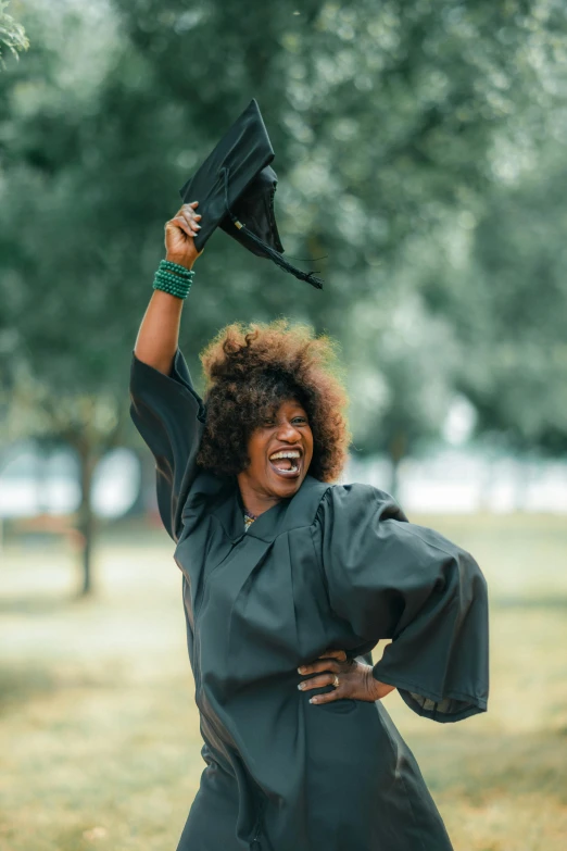 a woman in a dress lifts an umbrella