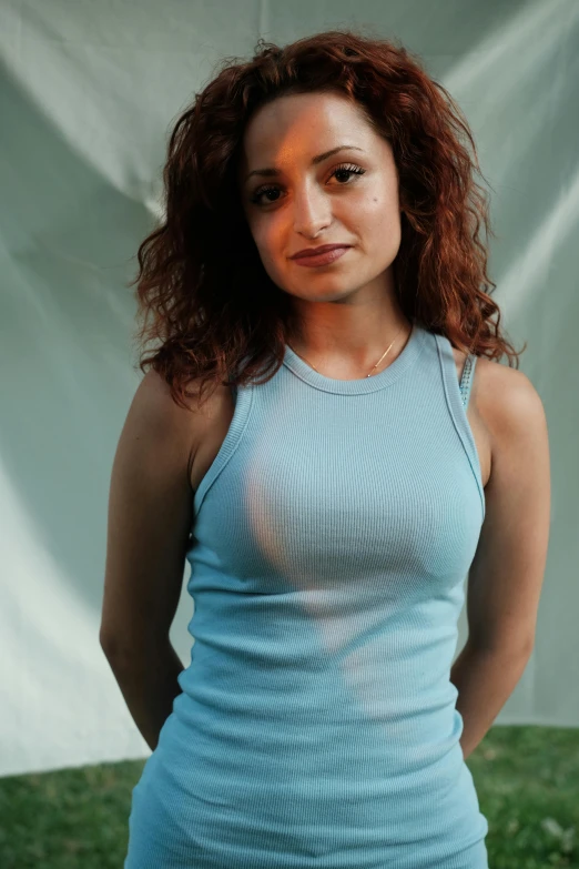 a woman posing for a picture wearing a blue dress