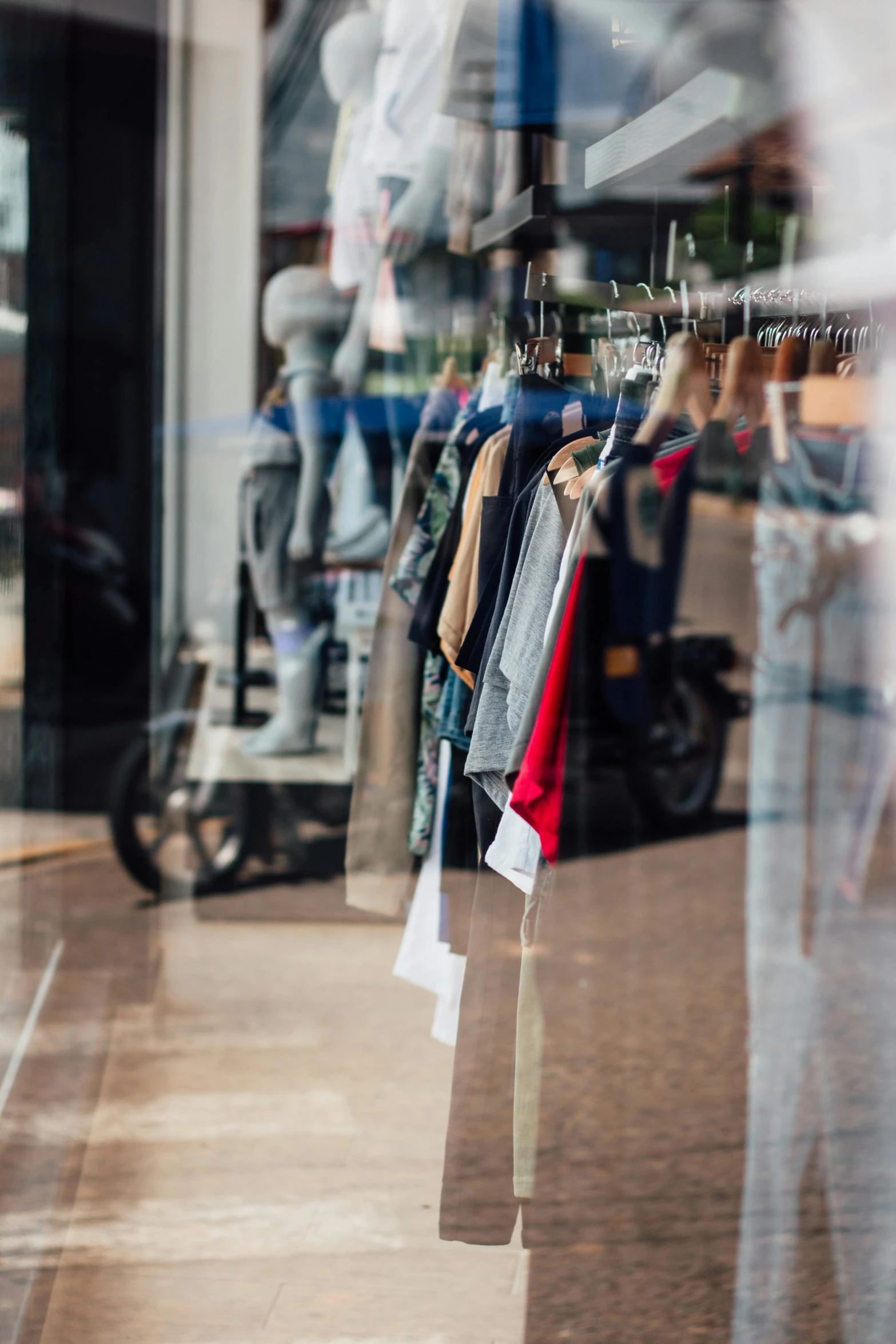 a bunch of jackets are hanging on clothes racks