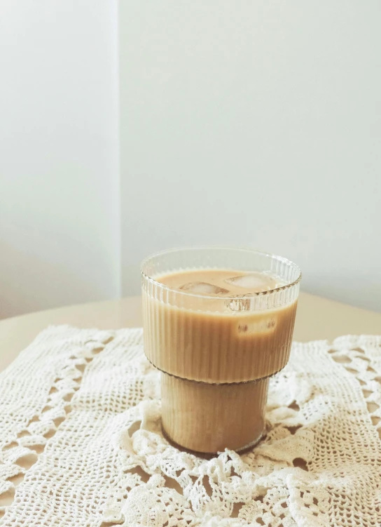 a glass container with liquid sitting on a table