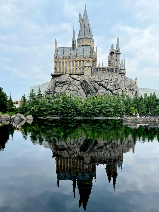 the castle is surrounded by trees and water